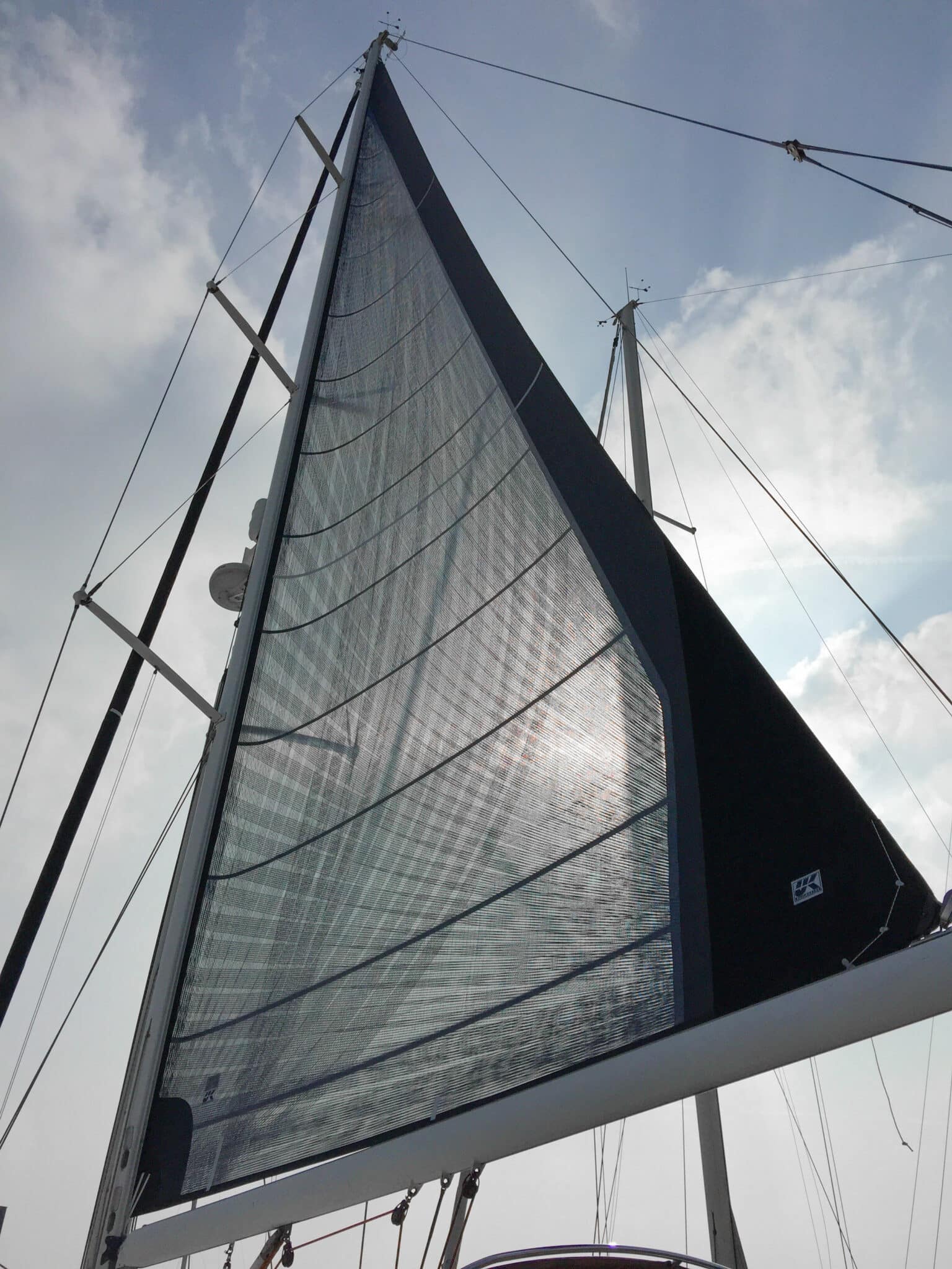 X-Drive in-mast furling mainsail with corner-to-corner load-path fibers visible across the sail