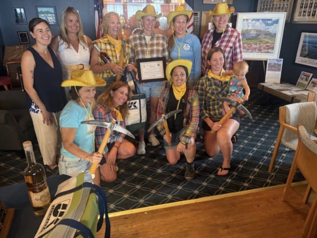 Racing and Winning for a Cause 2 Karen Harris and the crew of Assarain IV collect their UK Sailmakers Northeast prize after winning the Traditional Non-Spinnaker Division.